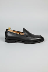 Black leather slip-on loafers with a textured finish for formal and casual wear.